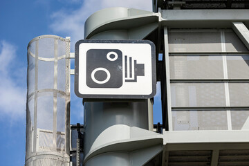 close up of a uk speed camera sign on a overhead gantry, overhead signage