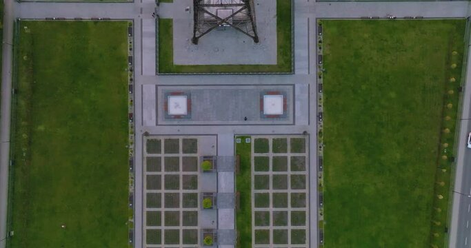 Aerial view of the wooden broadcasting tower in Gliwice with the city of Gliwice in the background. The concept of the largest wooden tower in the world. Wooden construction from a drone.