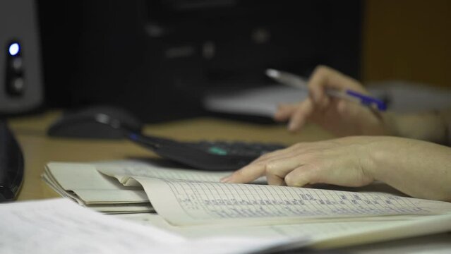 HD. Close-up of the manager's hands checking documents on the desk in the office