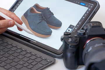 Paris, France - 08 02 2022: still life. Studio shot detail of a tablet, stylus, keyboard, screen, camera and a pair of men's shoes with blue laces and brown soles - Powered by Adobe