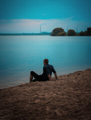 Fototapeta premium a series of photographs of a man barefoot near the water in the evening