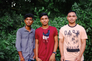 Young south asian friends standing together  in a natural environment wearing casual dresses , Bangladeshi brothers in outdoor
