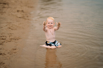 a boy plays in the water of a large lake in the Lipetsk region