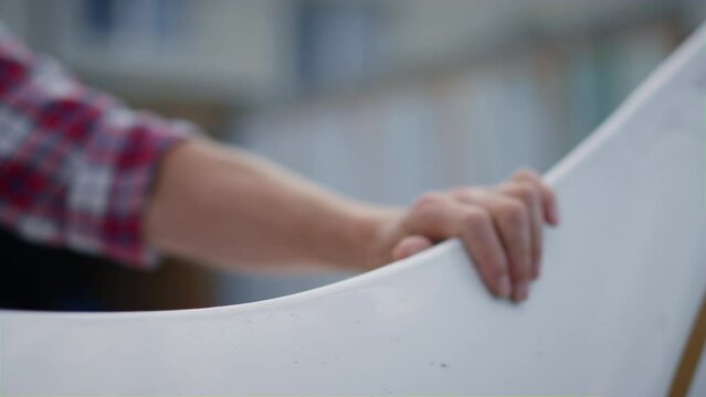 Pilot hand touching airplane wing for flight close up. Aviator inspecting plane.