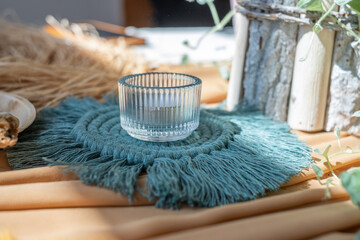Creative lay composition with textile, twine spool, glass, wood, plant and crochet sample. Cozy interior moodboard. 