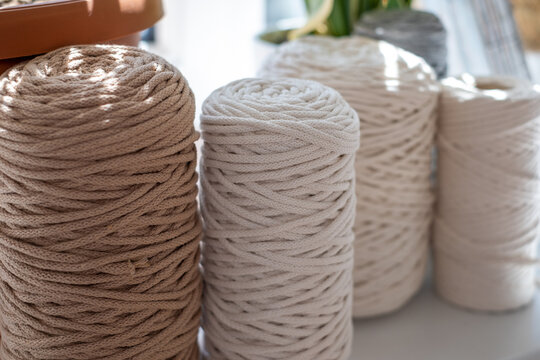 Close-up of natural cotton twine spools on blurred background. Excellent image for handcrafts banners and advertisements.