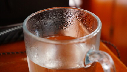 Glass to drink from with clear warm water. To quench thirst and replenish fluids. A healthy lifestyle without additives and calories.