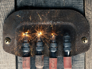 Third Advent background with four spark plugs on rusty sign, car workshop advent