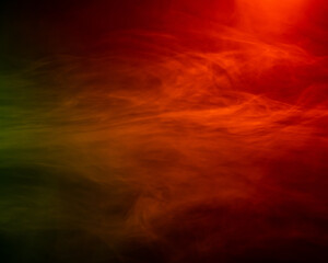 Obraz na płótnie Canvas Red smoke flows on a black background. 
