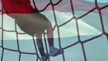 Animation of flag of netherlands over caucasian boy during obstacle race training - Powered by Adobe