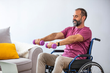 Fototapeta na wymiar Serious sportsman sitting in wheelchair and outstretching arms with dumbbells during rehabilitation exercise in modern medical center. Man sitting on wheelchair at home, arms stretched.