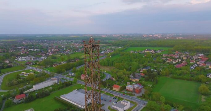 Aerial view of the wooden broadcasting tower in Gliwice with the city of Gliwice in the background. The concept of the largest wooden tower in the world. Wooden construction from a drone.