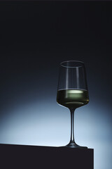 White wine in a transparent glass in low key	