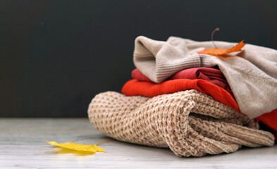 Autumn clothes. Sweater and maple leaf