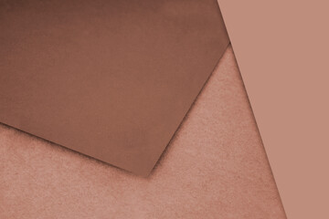 Fototapeta premium Plain and Textured pastel brown papers randomly laying to form M like pattern and triangle for creative cover design idea