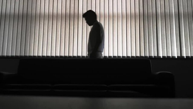 stressed man in a dark room