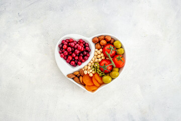 Healthy lifestyle and nutrition eating concept with food in heart shaped dish