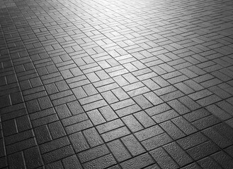 tile floor of pavement with sunlight in street