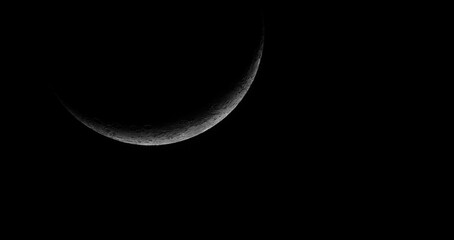 crescent moon against black night sky background