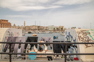 wetsuits drying in Bari Harbour, Apulia, Italy