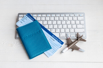 Booking tickets online - passport with air tickets on keyboard