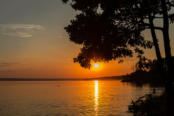 Fototapeta na wymiar Sunset over the lake. Summer evening