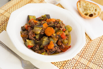 dish of vegetable stew. stewed eggplant, minced meat, carrots, peppers, onion squid