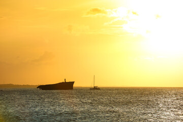 Sunset on the sea of Fortaleza with silhouette of a shipwreck