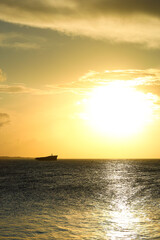 Naklejka na ściany i meble Sunset on the sea of Fortaleza with silhouette of a shipwreck