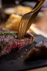 Delicious beef steak served with french fries with parmesan and rosemary