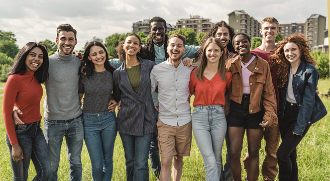 Horizontal view of crowd of cheerful attractive multi-ethnic best friends standing outdoors pose smiling looking at camera feels happy - millennial generation students people concept