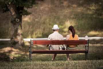 Couple sitting on a bench in the park