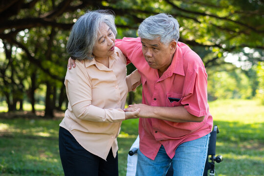 Asian Senior Man Falling Down On Lying Floor At Park After Stumbled  And Crying In Pain And Him Wife Came To Help Support. Concept Of Old Elderly Insurance And Health Care