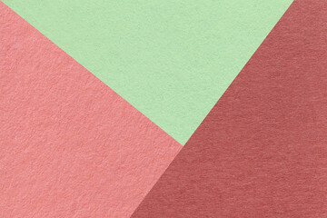 Texture of craft red, pink and green shade color paper background, macro. Structure of vintage abstract rose cardboard