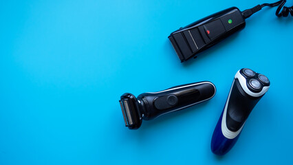 Electric razor of different types on a blue background close-up. Razor. Male set.