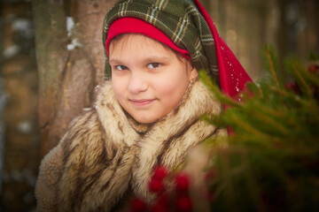 Portrait of a nice cute teenager girl in old peasant clothes with hot fur coat and shawl in cold...