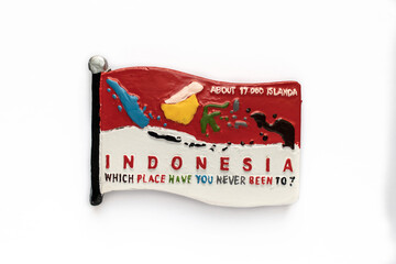 Colorful souvenir fridge magnet from Indonesia isolated on white background.