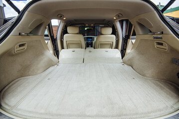 Luxury car boot with folded seats. Opened empty car trunk. Clean trunk of the SUV. Organization of...