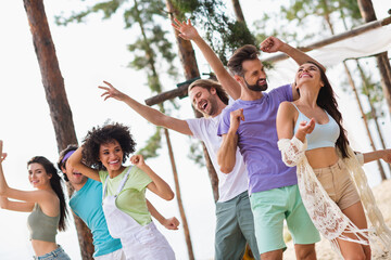 Photo of group overjoyed cheerful people enjoy dancing rejoice free time discotheque outside
