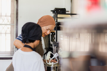 Mother and son baking cake together in kitchen at home.