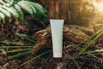 Mockup of a tube for cream on a natural background in the forest, an environmentally friendly product, natural components