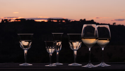 Elegant wine glasses at sunset