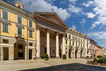 Cuneo, Piedmont Italy - August 6, 2022: the Cathedral of St Mary of the Woods , the facade by Antonio Bono with 4 Corinthian columns,  portico and tympanum and historic buildings in Via Roma