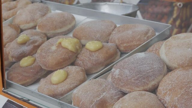 assortment of various cream-filled Berlin donuts
