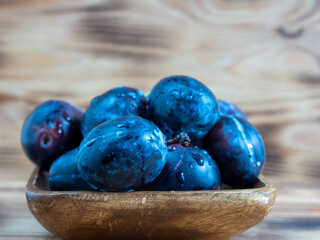 Fresh juicy plums. Plums on a wooden background.