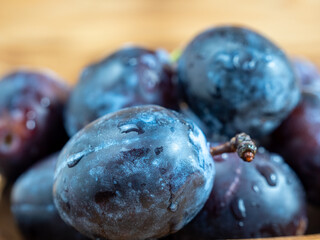 Fresh juicy plums. Plums on a wooden background.