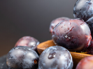 Fresh juicy plums. Plums on a black background.