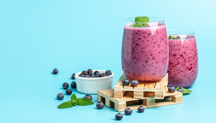 blueberry smoothie Yogurt fruit dessert on a blue background. Berry smoothie. healthy dieting...