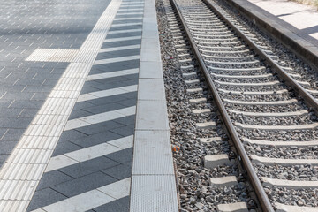 Safety warning line on a train platform, mind the gap