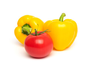 Fresh vegetables, whole red tomato and yellow bell pepper (paprika) isolated on white background